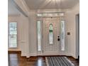 Welcoming entryway with decorative glass door and sidelights and hardwood flooring at 2530 Ashbourne Dr, Lawrenceville, GA 30043