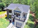 Stunning modern home featuring an elevated balcony and lush green surroundings at 4366 Bradley Sw Dr, Snellville, GA 30039