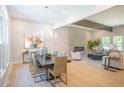 Open concept living room and dining area featuring modern decor and a sleek fireplace at 4366 Bradley Sw Dr, Snellville, GA 30039