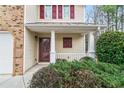 Inviting front porch with white columns and manicured bushes framing the entrance at 184 Darbys Crossing Ct, Hiram, GA 30141
