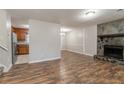 Open-concept space with fireplace, wood floors, and entry to kitchen at 5218 Tina Ct, Stone Mountain, GA 30083