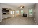 Open-concept living room features a fireplace and seamless flow into the kitchen and dining area at 545 Offaly Ln, Atlanta, GA 30349