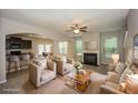 Staged living room with a fireplace and open layout leading to the kitchen and dining area at 545 Offaly Ln, Atlanta, GA 30349