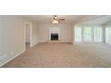 Spacious living room featuring a fireplace and large windows providing natural light at 2799 Lake Jodeco Rd, Jonesboro, GA 30236