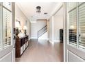 Inviting foyer with hardwood floors, staircase, and view of a bright interior at 3900 Danube Ln, Atlanta, GA 30339