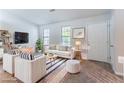 Bright living room featuring modern furniture, a striped rug, and ample natural light at 4766 White Oak Path, Stone Mountain, GA 30088