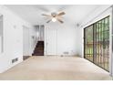 Living room featuring stairs, doors, and sliding glass doors leading to the outside deck at 6535 Buckhurst Trl, Atlanta, GA 30349