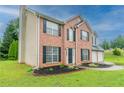 A classic brick facade and a two-car garage complement the well-maintained front yard at 6683 Princeton Park Ct, Lithonia, GA 30058