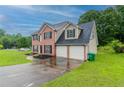 Classic brick home featuring an attached two-car garage and a well-manicured lawn at 6683 Princeton Park Ct, Lithonia, GA 30058