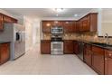 This kitchen features stainless steel appliances, granite countertops and rich wood cabinets at 6683 Princeton Park Ct, Lithonia, GA 30058