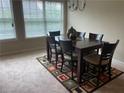 Dining room featuring a wooden table with six chairs, neutral walls, and natural light at 805 Pleasant Hill Nw Rd # 53, Lilburn, GA 30047