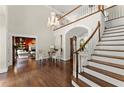 Spacious foyer with hardwood floors, staircase, and elegant chandelier at 4161 Thunderbird Se Dr, Marietta, GA 30067