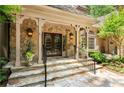 Stone entryway with decorative glass double doors and manicured landscaping creating curb appeal at 4161 Thunderbird Se Dr, Marietta, GA 30067