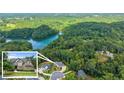 A sprawling property surrounded by lush forest and a glistening lake, offering privacy and stunning natural beauty at 6625 Baywood Run, Cumming, GA 30041