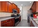 A cozy kitchen featuring sleek countertops, stainless steel appliances, and dark wood cabinetry at 780 Nehemiah Sw Ln, Atlanta, GA 30331