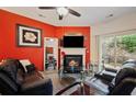 A modern living room featuring a fireplace, comfortable seating, and a sliding door to the backyard at 780 Nehemiah Sw Ln, Atlanta, GA 30331