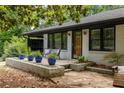 Charming home with a well-maintained front garden, stone walkway, and inviting entrance at 1195 Russell Dr, Decatur, GA 30030
