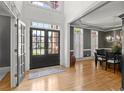 Elegant entryway with double doors, gleaming hardwood floors, and sophisticated dining room view at 1860 Hill Chase, Alpharetta, GA 30022