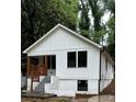 Quaint front view of a board and batten home with a small porch and dark frame windows at 2004 Detroit Nw Ave, Atlanta, GA 30314