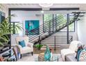 Stylish living room featuring sleek staircase, eye-catching artwork, and contemporary decor at 240 Patterson Se Ave, Atlanta, GA 30316