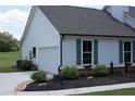 A charming home with an attached garage, well-maintained landscaping, and a paved driveway at 2980 Hd Atha Rd, Covington, GA 30014