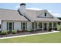 Beautiful single-story home with a covered porch, showcasing gray shutters and a well-manicured lawn at 2980 Hd Atha Rd, Covington, GA 30014