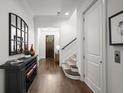 Bright hallway with hardwood floors, leading to staircase and front door, with stylish decor at 4137 Avid Park, Marietta, GA 30062