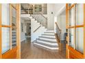 Bright foyer with hardwood floors and staircase with iron railings; viewed from the double front doors at 1096 Bridge Mill Ave, Canton, GA 30114