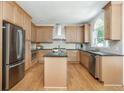 Well-lit kitchen featuring stainless steel appliances, light wood cabinets, and a functional center island at 1096 Bridge Mill Ave, Canton, GA 30114