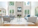 Airy living room with a soaring ceiling, a fireplace, hardwood floors, and an elegant neutral palette at 1096 Bridge Mill Ave, Canton, GA 30114