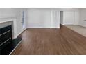 Spacious living room featuring hardwood floors and a fireplace with a white mantle at 4425 Amy Rd, Snellville, GA 30039