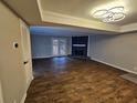 Open-concept living room with wood floors, modern lighting, and a cozy fireplace at 6002 Pat Mell Se Pl, Smyrna, GA 30080