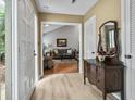 Charming foyer with hardwood floors, traditional furniture, and a glimpse into the cozy living room at 663 Serramonte Dr, Marietta, GA 30068
