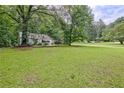 Traditional one-story house with a wide lawn and mature trees in a serene setting at 1774 Willis Mill Rd, Atlanta, GA 30311