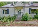Welcoming entrance to a charming home with blue shutters, ready for a personal touch at 1774 Willis Mill Rd, Atlanta, GA 30311