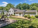 Spacious backyard featuring a lawn, landscaping, and a playset at 237 Lamplighter Ln, Marietta, GA 30067