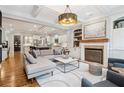 Bright open-concept living room open to the kitchen, a fireplace, and neutral decor at 4588 Pine Se St, Smyrna, GA 30080