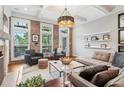 Comfortable living room featuring exposed brick wall, an area rug, and stylish decor at 4588 Pine Se St, Smyrna, GA 30080