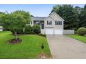 Well-maintained home with a lush green lawn and mature trees at 74 Knights Ct, Dallas, GA 30157