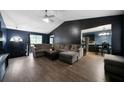 Cozy living room featuring wood floors, a ceiling fan, and vaulted ceiling at 74 Knights Ct, Dallas, GA 30157