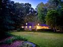 Beautiful lush green lawn highlighting a quaint stone home with a cozy, inviting ambiance at 2596 Midway Rd, Decatur, GA 30030