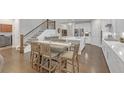 Open kitchen with a center island, stainless steel appliances, breakfast bar and hardwood floors at 267 Snow Owl Way, Lawrenceville, GA 30044
