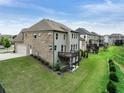 Spacious backyard with a small deck on a brick and siding home at 3525 Montebello Pkwy, Cumming, GA 30028