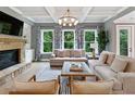 Beautiful living room with coffered ceiling, stone fireplace, and large windows at 3525 Montebello Pkwy, Cumming, GA 30028