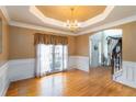 Elegant dining room boasting hardwood floors, crown molding, and natural light at 3780 Summit Gate Dr, Suwanee, GA 30024