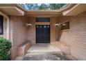 Close up of the double front doors of this brick home, showing decorative planters flanking the entryway at 3946 Flakes Mill Rd, Decatur, GA 30034