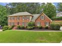 Traditional brick home with neat landscaping and a spacious front lawn, ideal for families at 5545 Durrett Dr, Atlanta, GA 30338