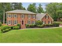 Stately brick residence showcasing lush landscaping and a welcoming front entrance at 5545 Durrett Dr, Atlanta, GA 30338