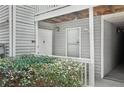 Exterior entryway featuring covered porch with white door, trim, and partial shrubbery at 1931 Brian Way, Decatur, GA 30033