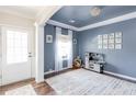 Inviting playroom with blue accent wall, white trim, natural light, and unique chandelier at 327 Nobleman Way, Canton, GA 30114